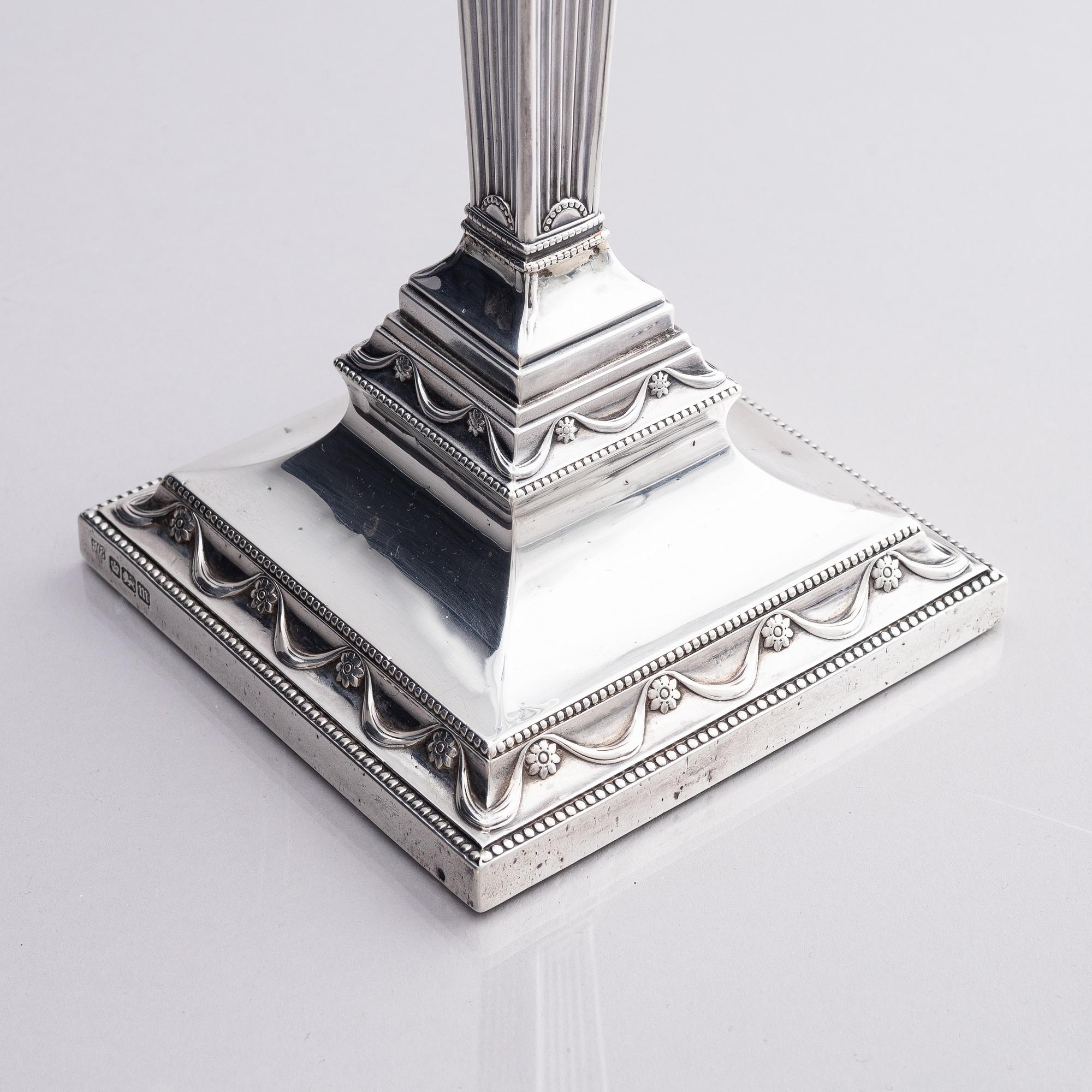 Four early 20th century silver candlesticks, marks of Hawksworth, Eyre & Co Ltd, Sheffield, England 1904-1906.