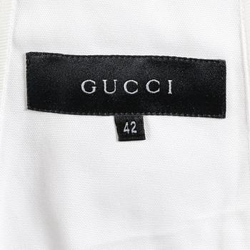 GUCCI, a white jacket.