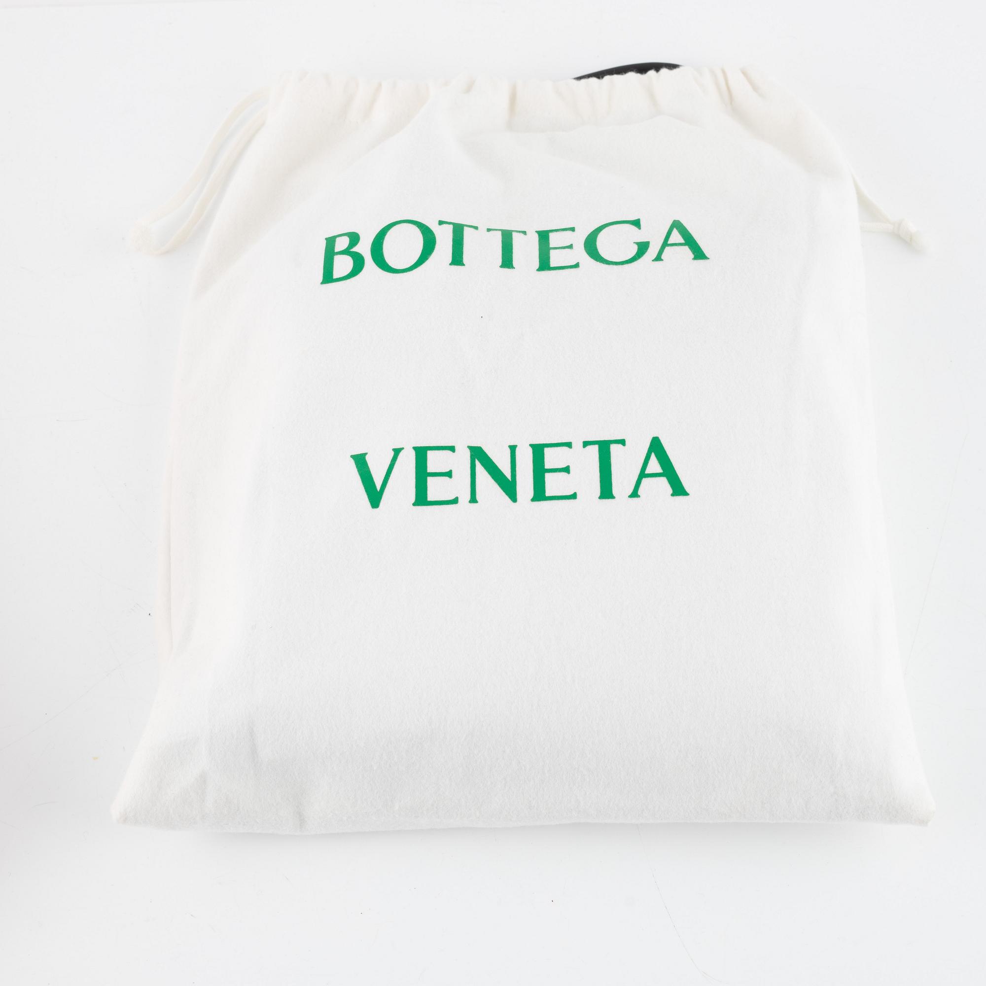 Bottega Veneta, a black leather handbag.