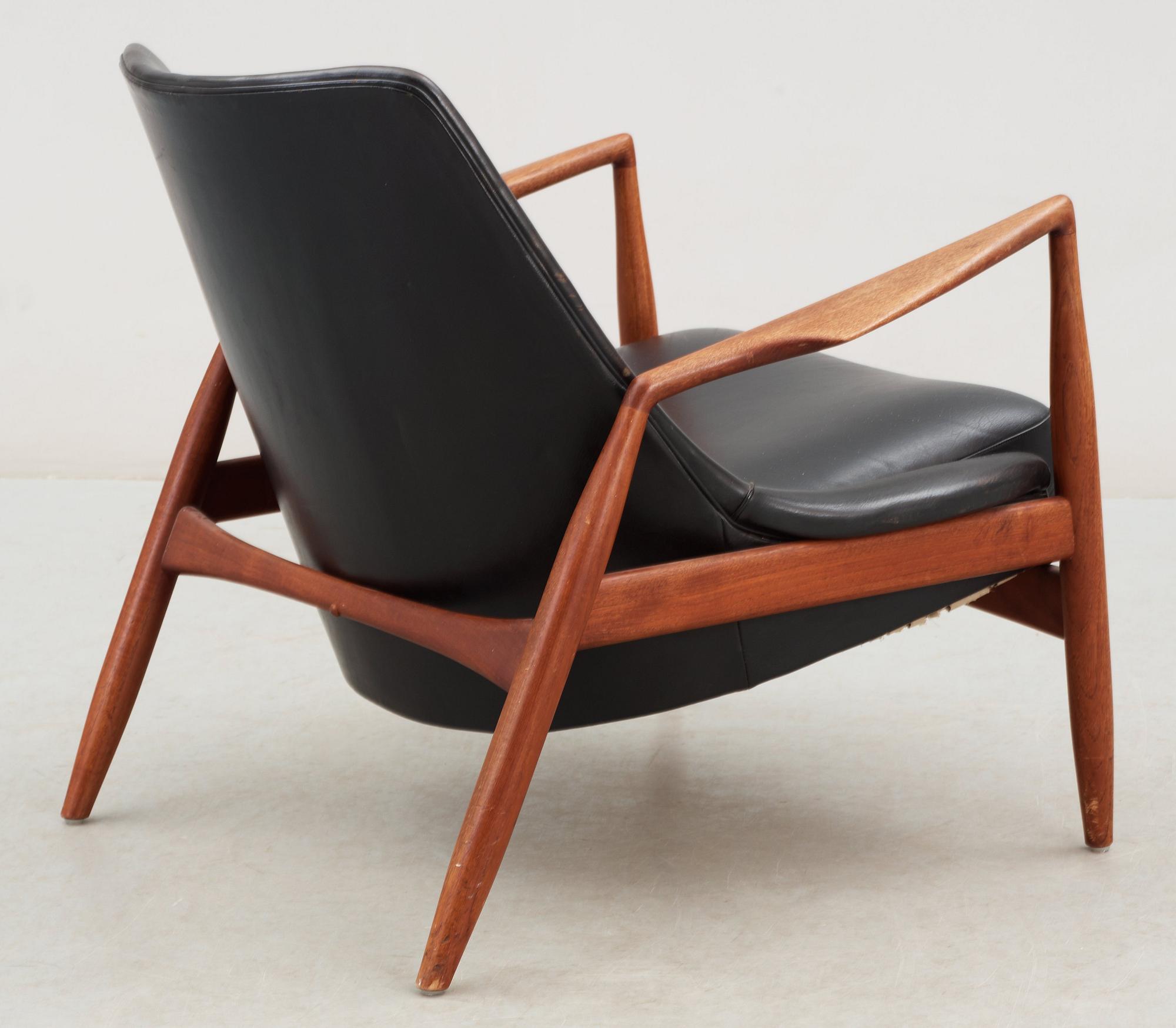 An Ib Kofod Larsen black leather and teak easy chair 'The Seal' by OPE, Sweden 1950-60's.