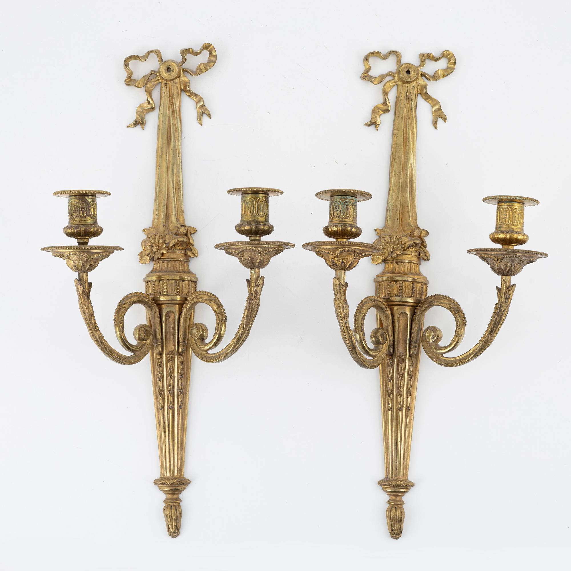 A pair of gilt brass wall sconces, Louis XVI-style, early 20th century.