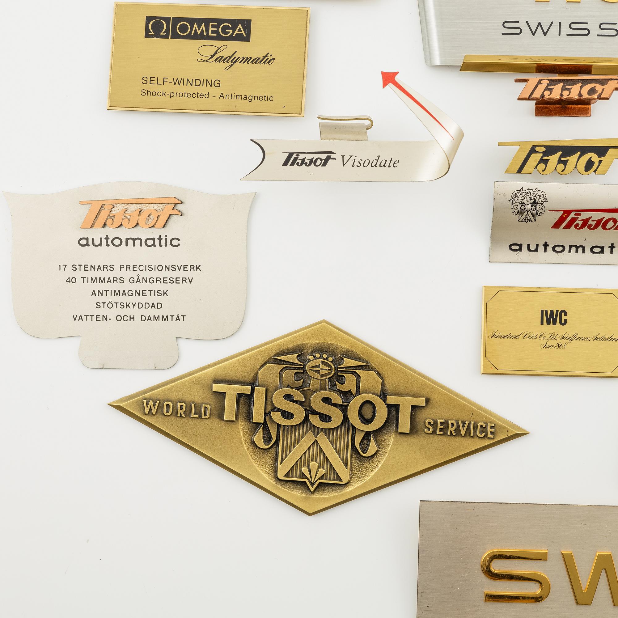 A collection of shop signs and agent plaques from Swiss watchmakers.