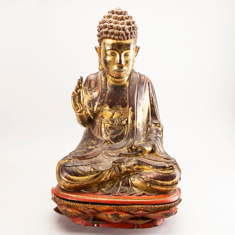 A large gilt and lacquered figure of a seated buddha, Qing dynasty, 19th Century.