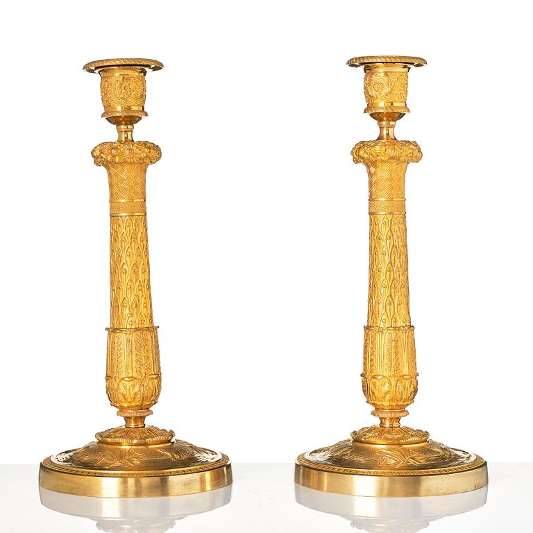 A pair of French Empire candlesticks.