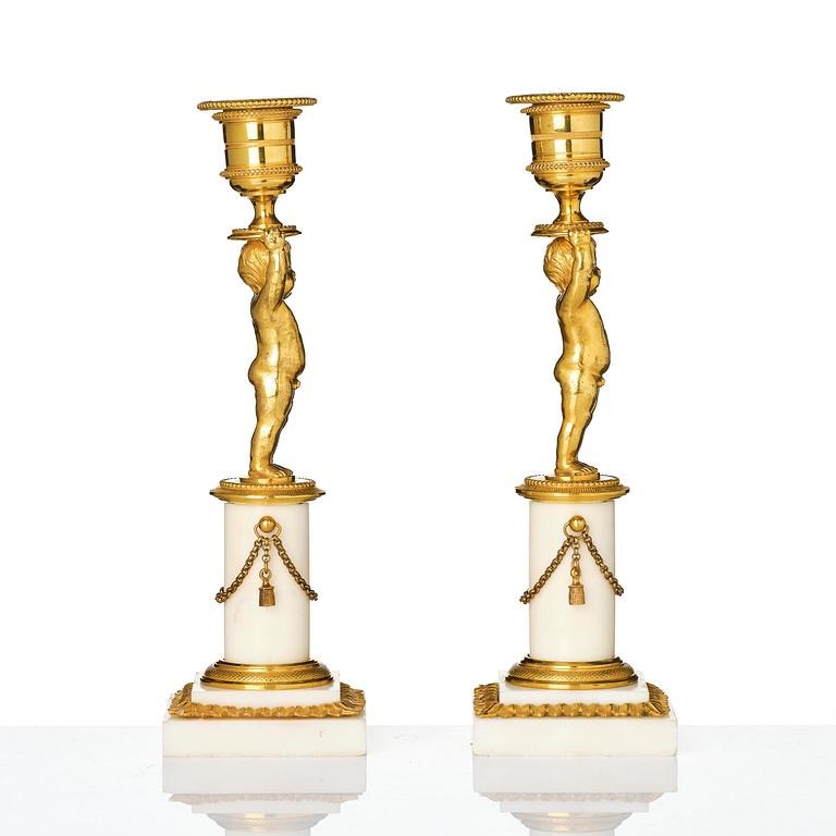 A pair of late Gustavian ormolu and white marble candlesticks, Stockholm, late 18th century.