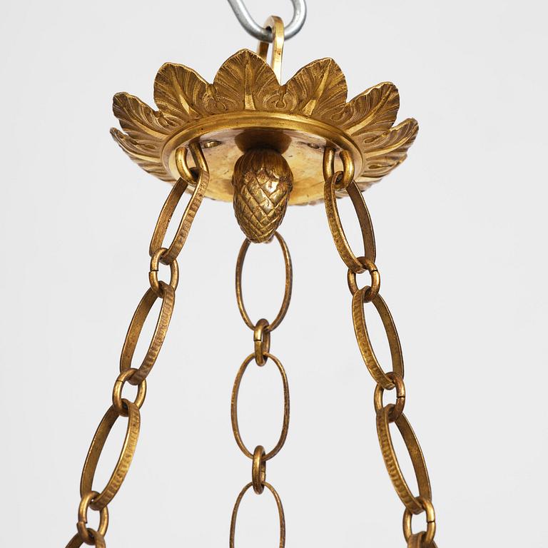 A patinated and ormolu six-light Empire chandelier, Stockholm, first part 19th century.