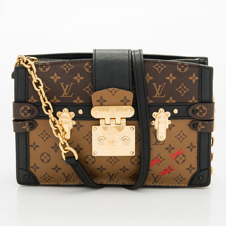 Louis Vuitton, a "Reverse Monogram Trunk Clutch" bag.