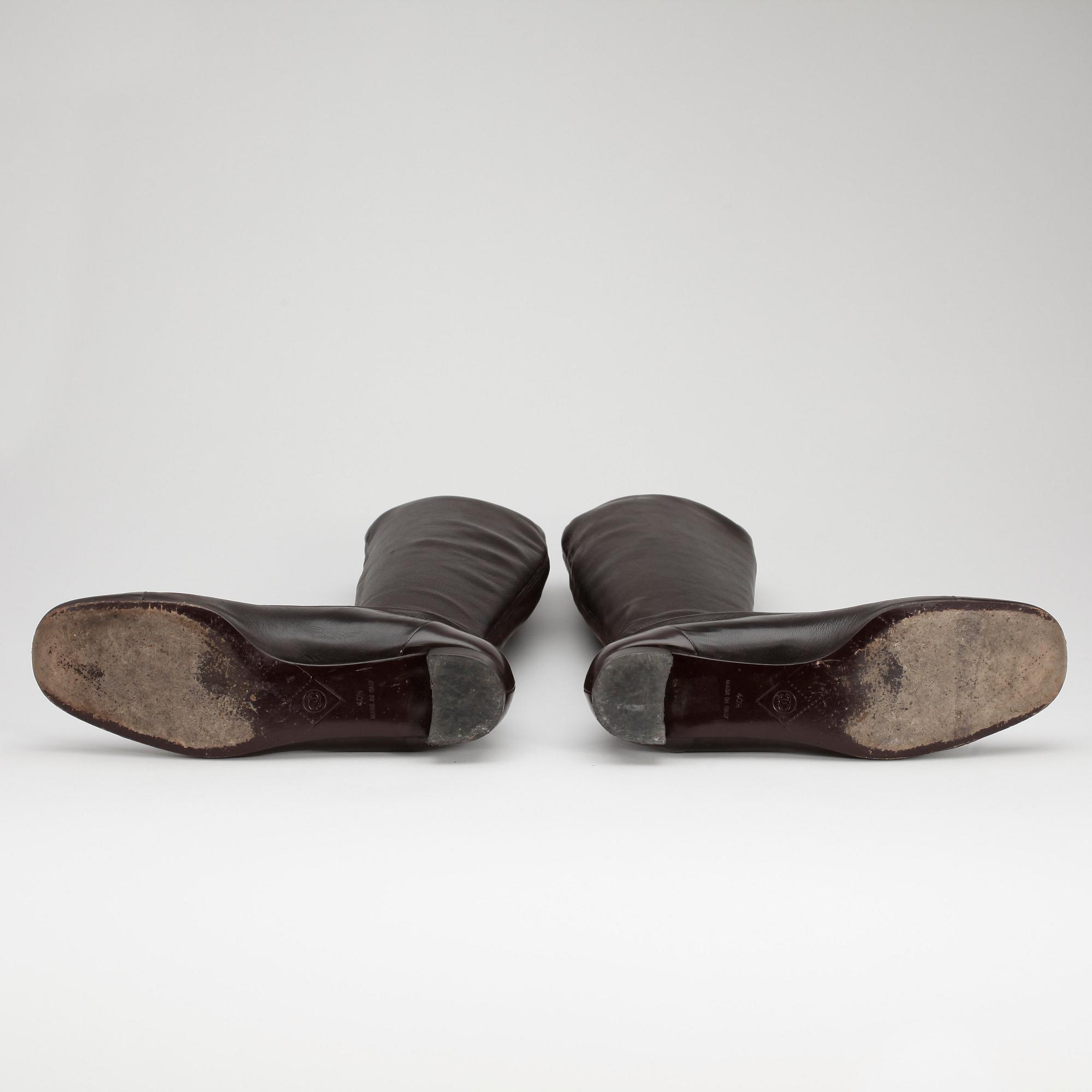 CHANEL a pair of brown leather boots.