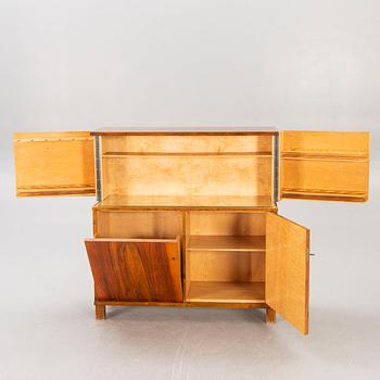 A 1930s birch bar cabinet.