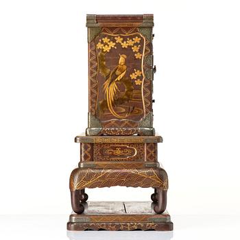 A Japanese lacquer cabinet on a stand, Meiji period (1868-1912).