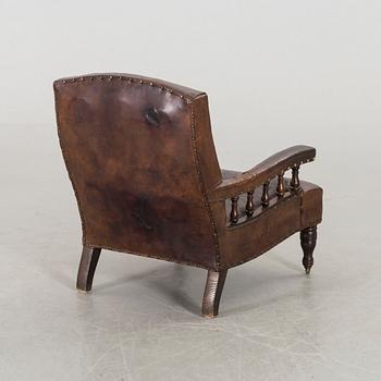 A LEATHER ARMCHAIR early 20th century.