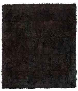 14. A carpet, sheepskins, black dark brown green melange, ca 547 x 492-498 cm.