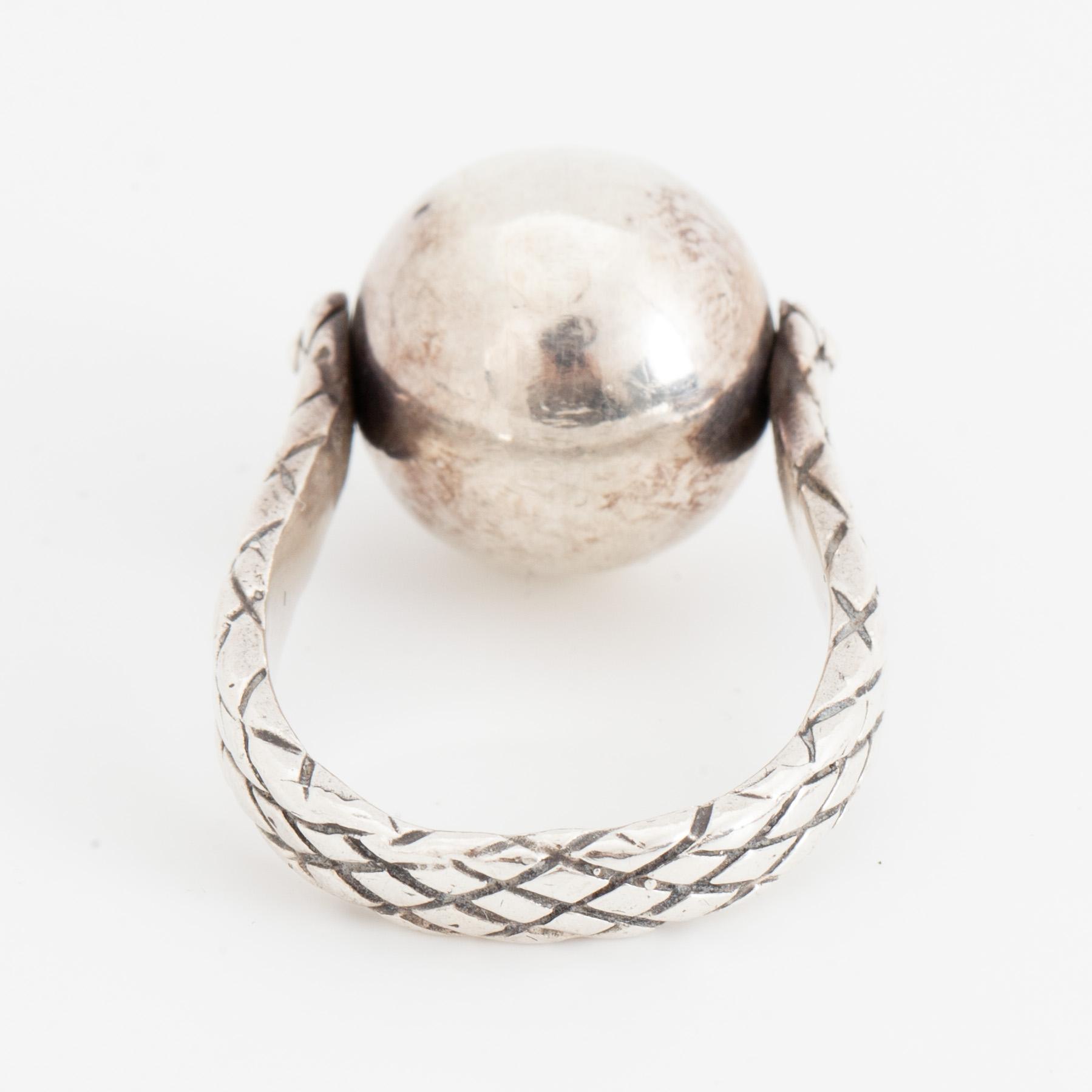 BOTTEGA VENETA, a pair of silver earrings and a silver ring.