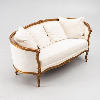 A Louis XV-style sofa, early 20th century.
