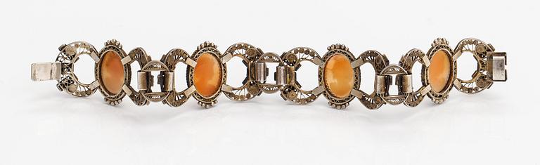A silver and sea shell cameo bracelet.