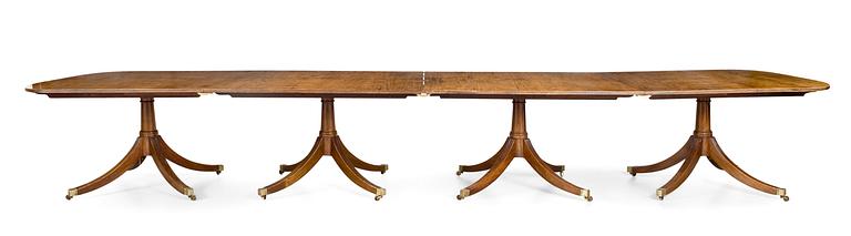 A Regency-style 20th century mahogany dinner table.