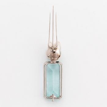 A Tina Karlsson a brooch in 18K white gold set with a large step-cut aquamarine and a cultured pearl.