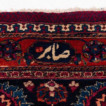 A Mashad carpet, signed Saber, c. 459 x 348 cm.