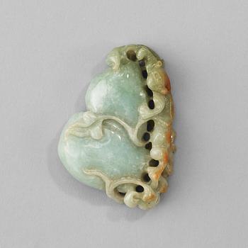 A Chinese nephrite sculpture of a qilin dragon on top of a gourd.