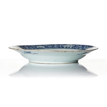 A blue and white 'reverse decorated' serving dish, Qing dynasty, Kangxi (1662-1722).