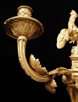 A pair of Louis XVI gilt bronze three-light wall-lights attributed to Jean-Louis Prieur, Paris circa 1770.