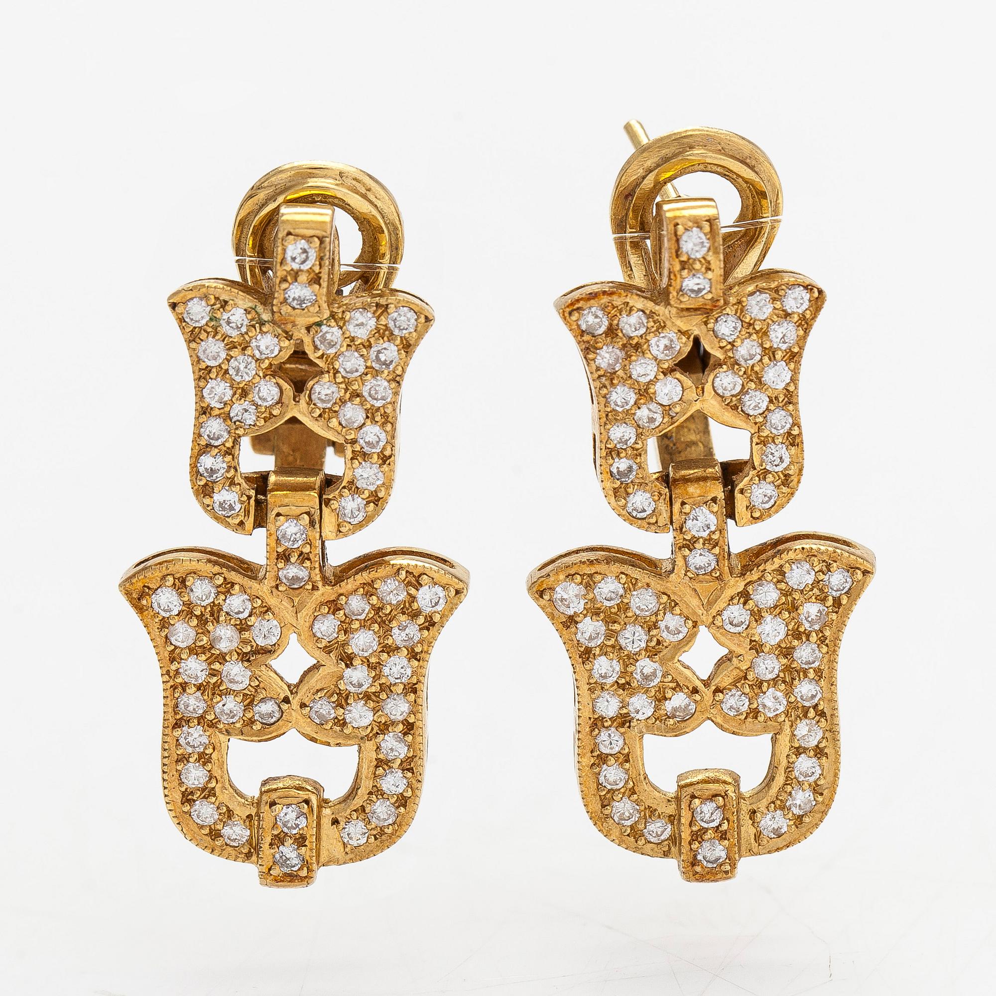 A pair of ca 18K gold earrings with diamonds totaling approximately 1.16 ct.