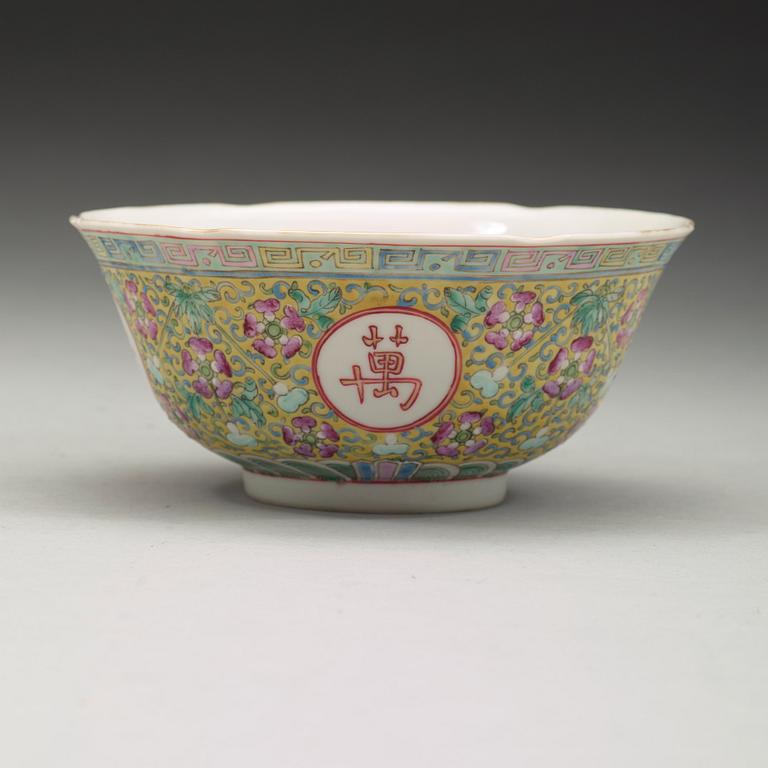 A famille rose yellow ground bowl. Late Qing dynasty, circa 1900, with Guangxu's six character mark.