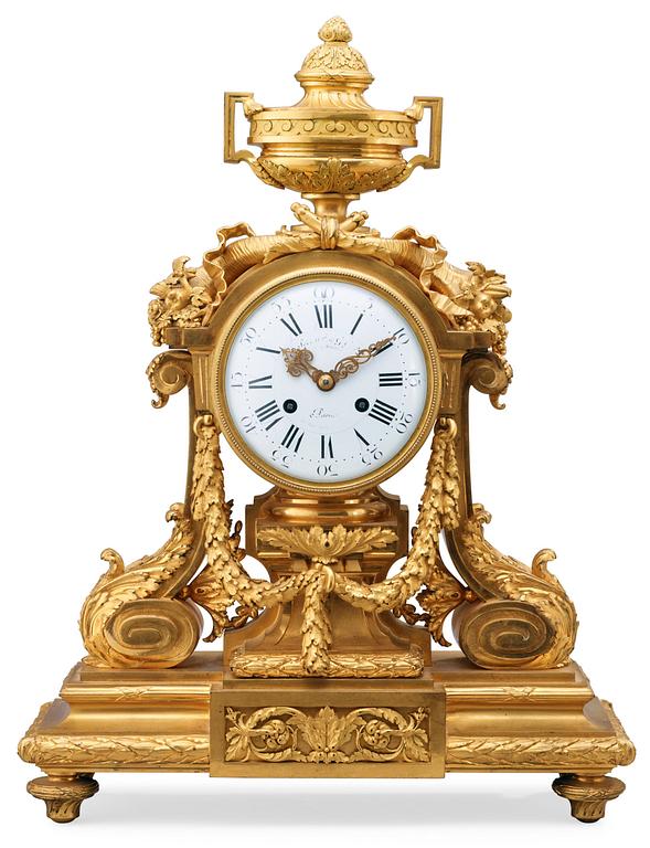 A Louis XVI-style late 19th Century gilt bronze mantel clock.