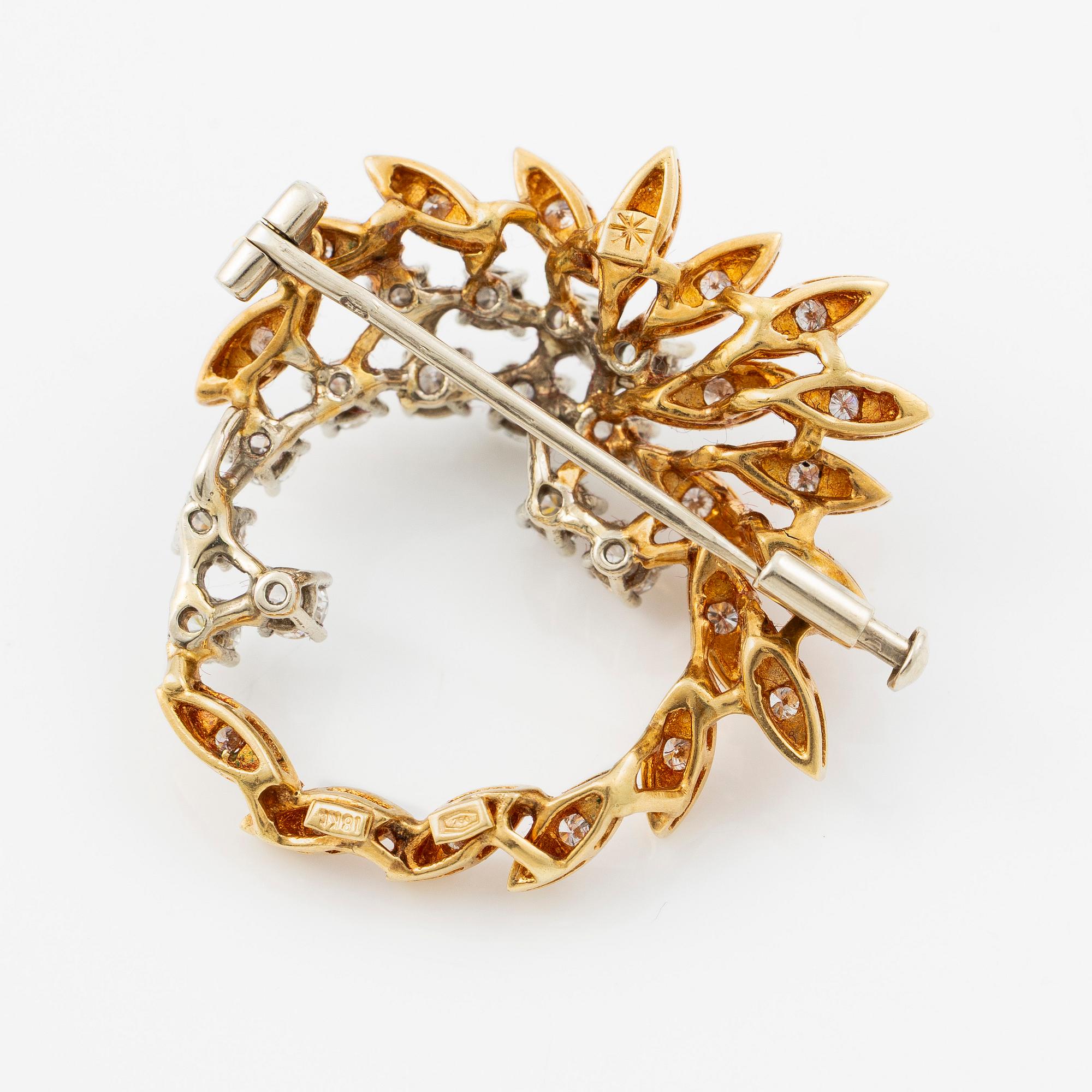 Brosch 18K guld med runda briljantslipade diamanter.