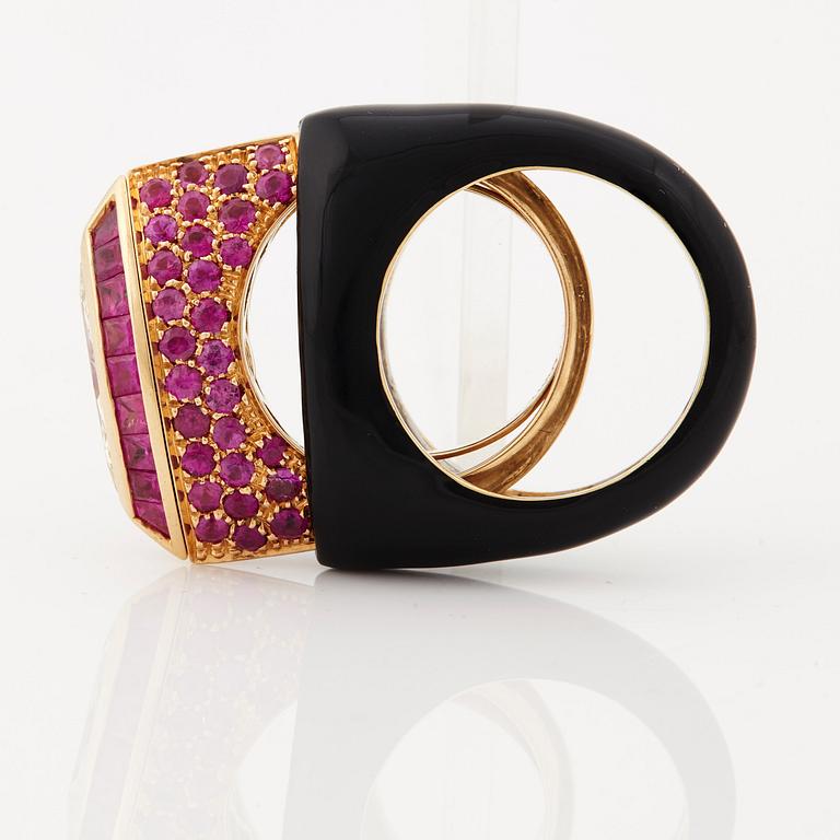 A ruby, diamond and black enamel ring.