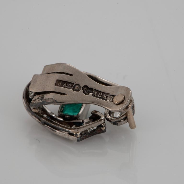 A pair of 18K white gold earrings set with faceted emeralds and old- and eight-cut diamonds.