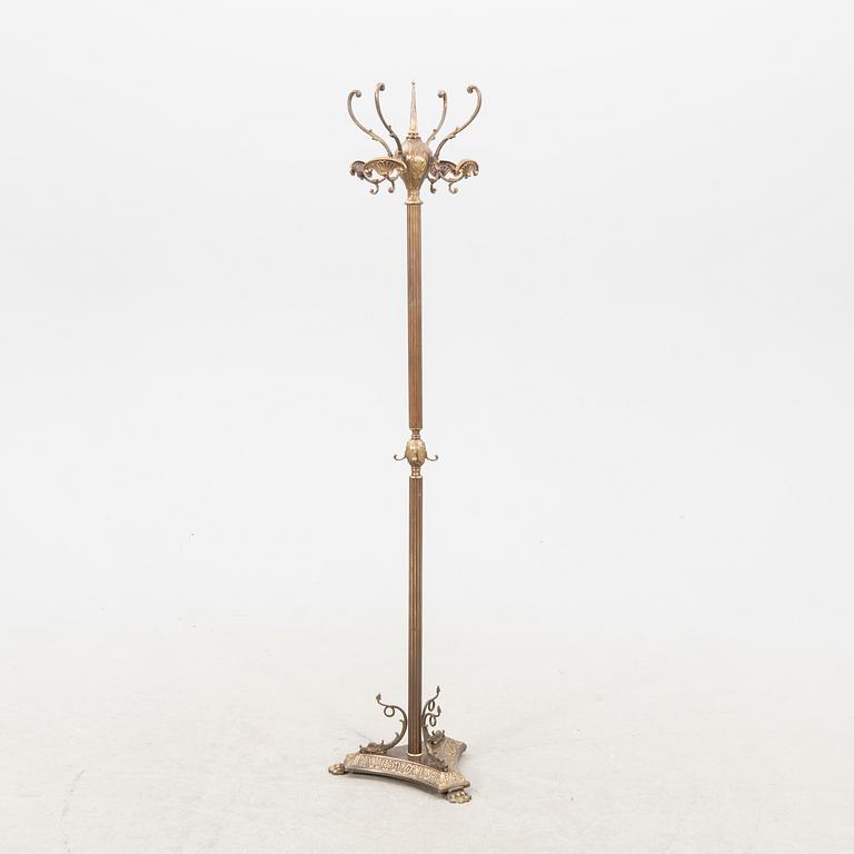A brass coat hanger from the first half of the 20th century.
