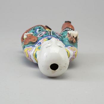 A porcelain figure of a laughing boy, Qing dynasty, 19th Century.