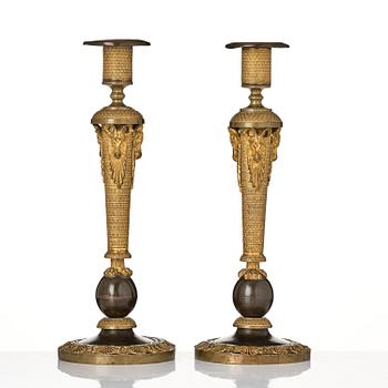 A pair of Russian Empire ormolu and patinated bronze candlesticks, Moscow circa 1800.