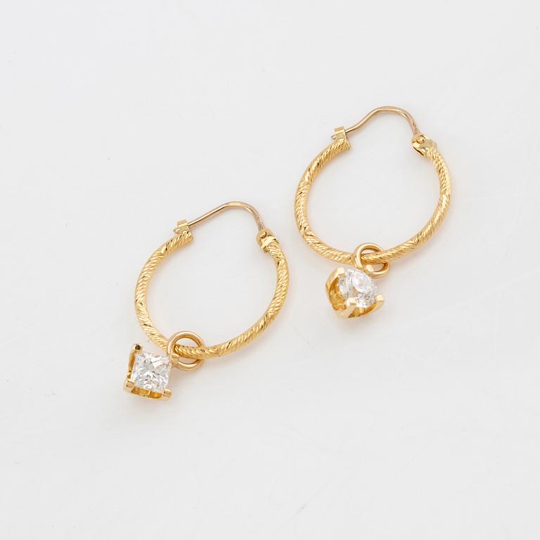 Earrings, a pair of hoops with pendants, one with a round brilliant-cut diamond, the other with a princess-cut diamond.