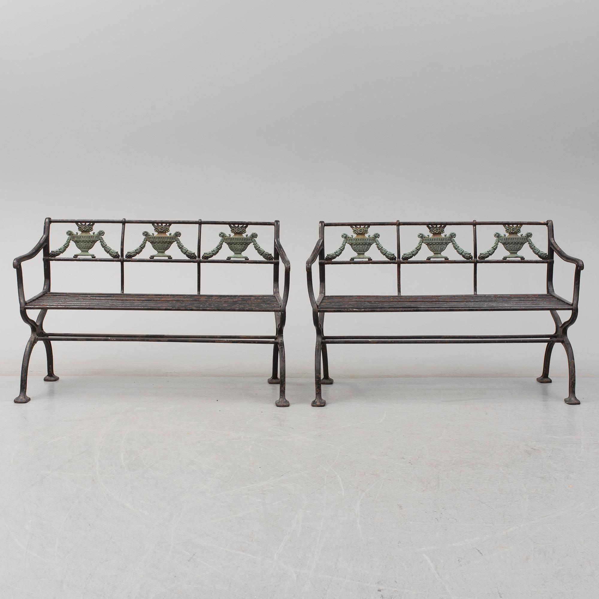 GARDEN SOFAS, a pair, cast iron, empire style, late 19th century.