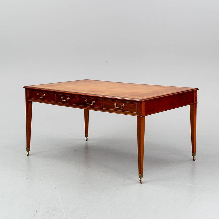 A contemporary mahogany and leather partners desk in the George III style.