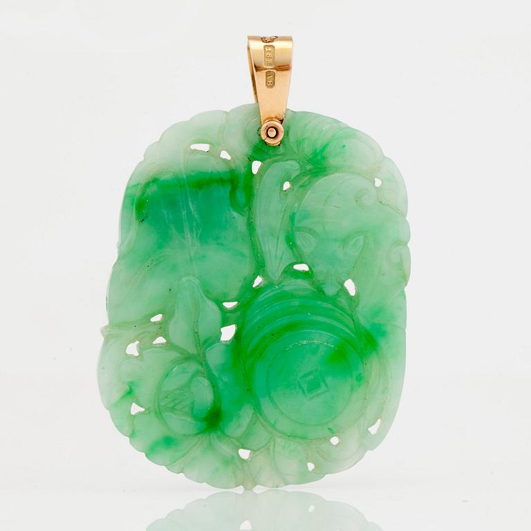 A carved jadeite pendant and earrings.