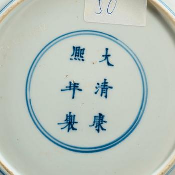 A set of four odd blue and white dinner plates, Qing dynasty, Kangxi (1662-1722), with different six character marks.