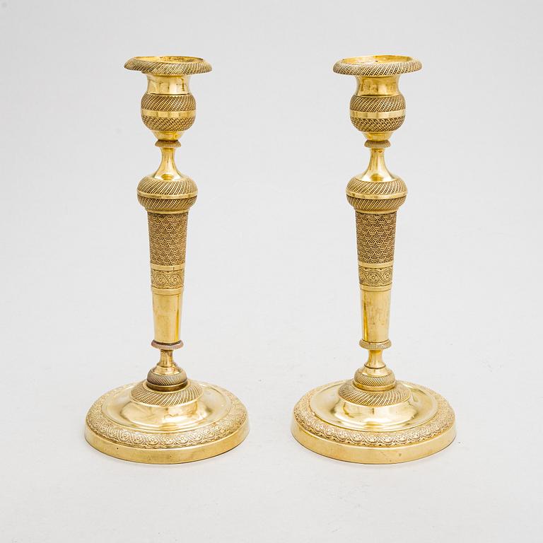 A pair of Empire bronze candlesticks from the first half of the 19th century.