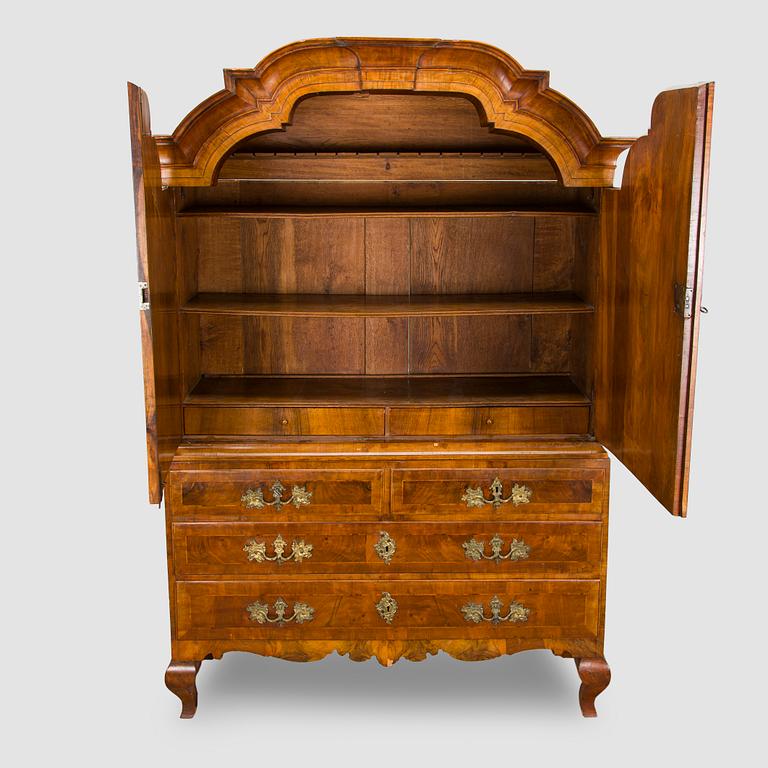 A Swedish walnut-veneered rococo cabinet in the manner of C. Linning, latter half of the 18th Century.