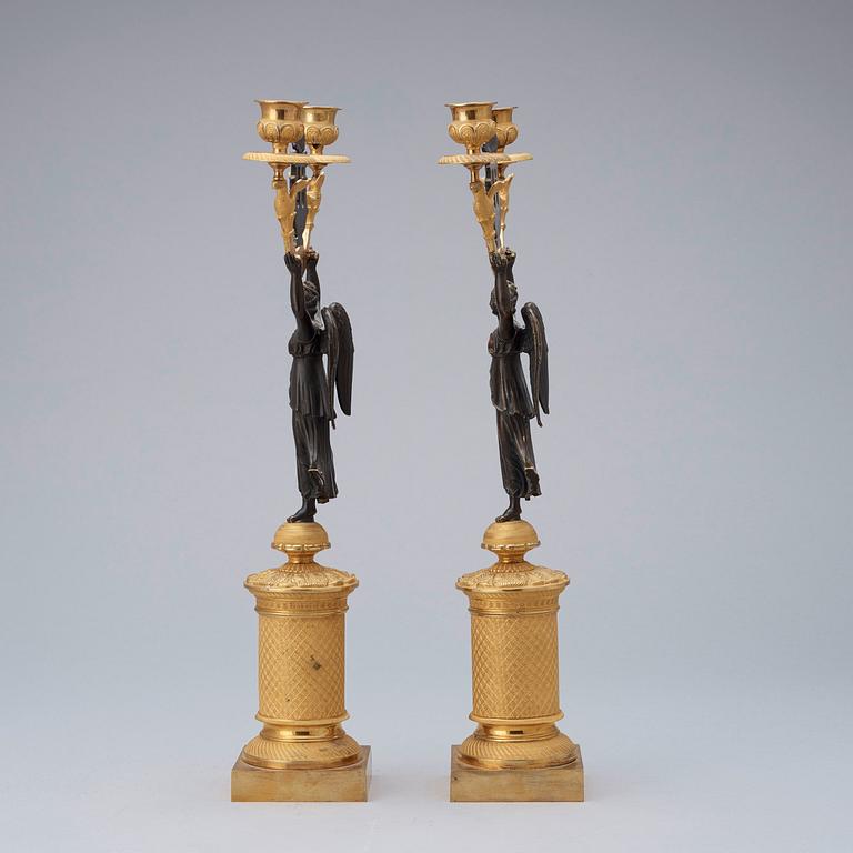 A pair of French Empire early 19th century candlesticks.