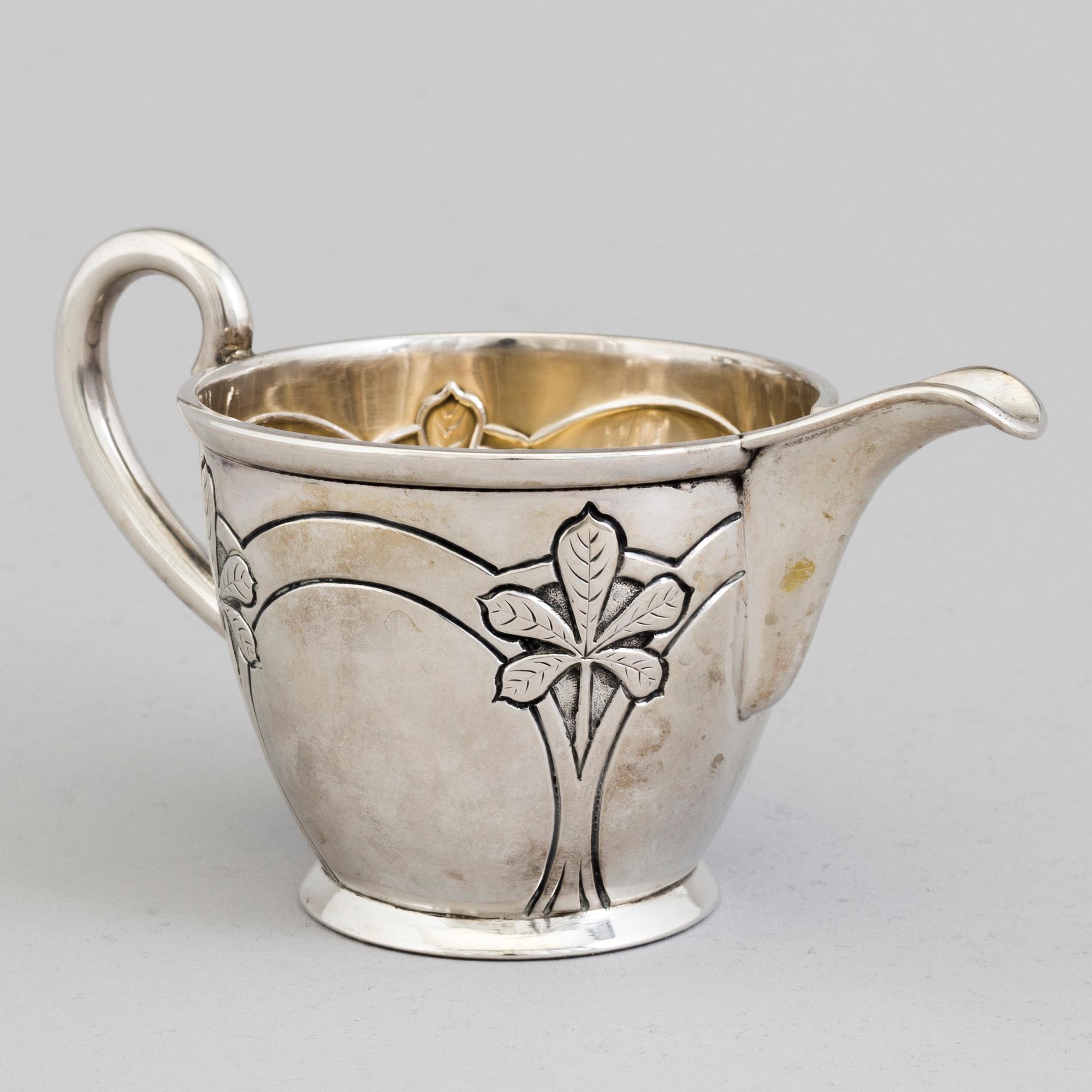 A Danish Art Nouveau parcel-gilt cream jug, maker's mark Franz Hingelberg, Aarhus 1909.