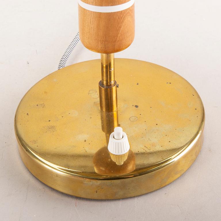 A Swedish Modern 1940s brass and wood lamp.