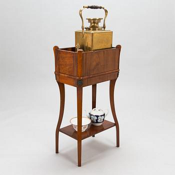 A brass samovar in a stand with a Kuznetsov porcelain teapot and bowl, latter half of the 19th century and early 1900s.