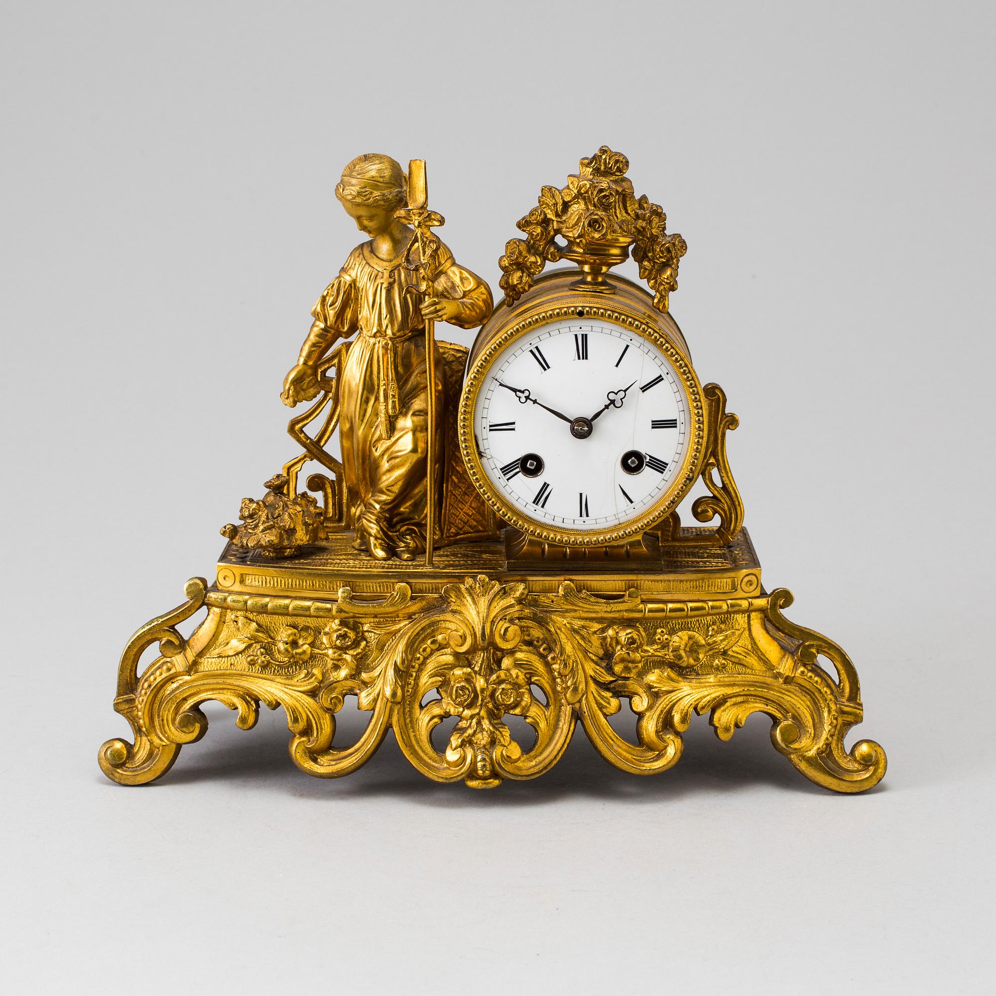 A LATE 19TH CENTURY GILT METAL MANTLE CLOCK in the Rococo style.