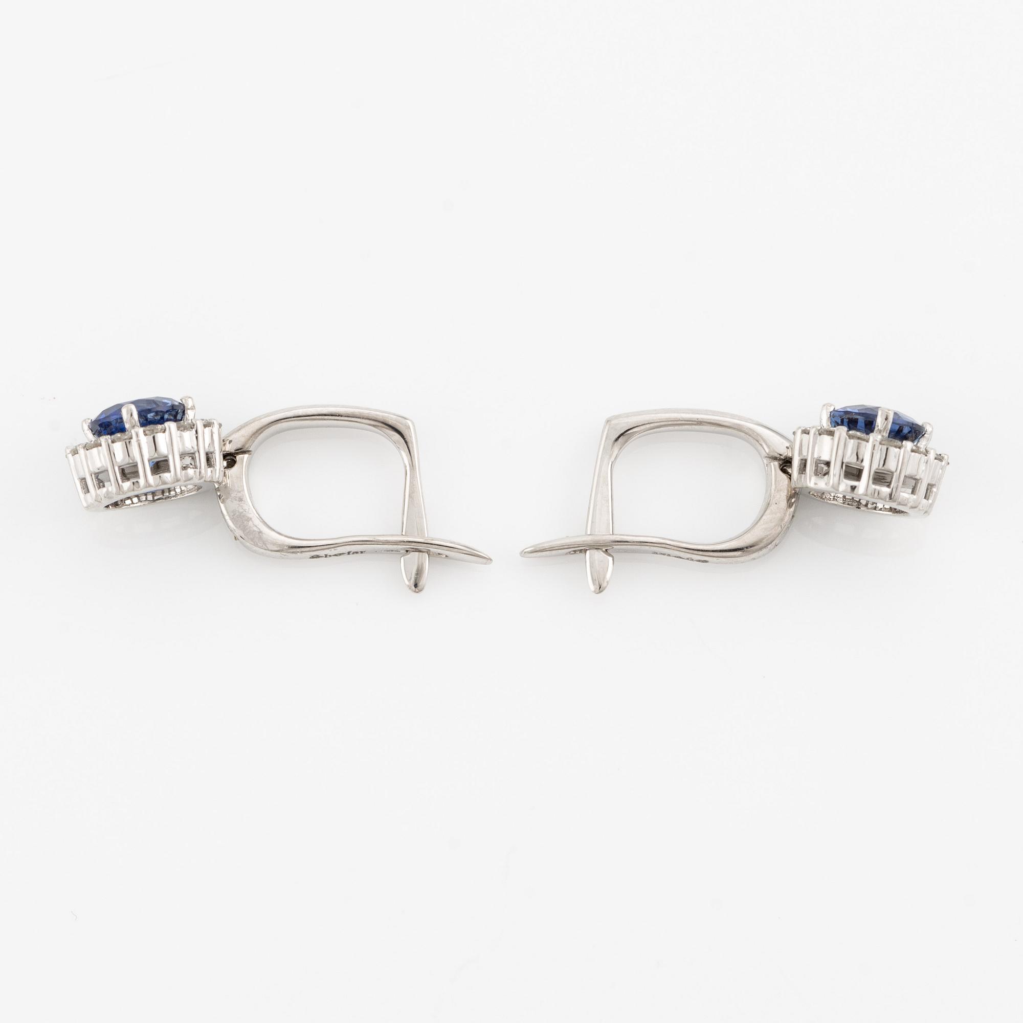 A pair of 14K gold earrings with faceted sapphires.