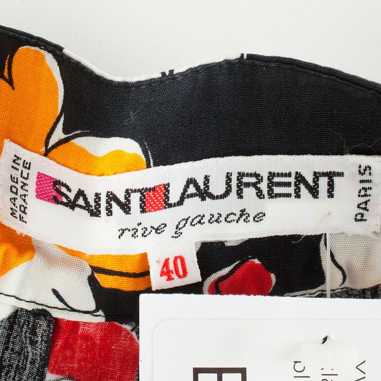 YVES SAINT LAURENT, a black cotton dress with flower motif.