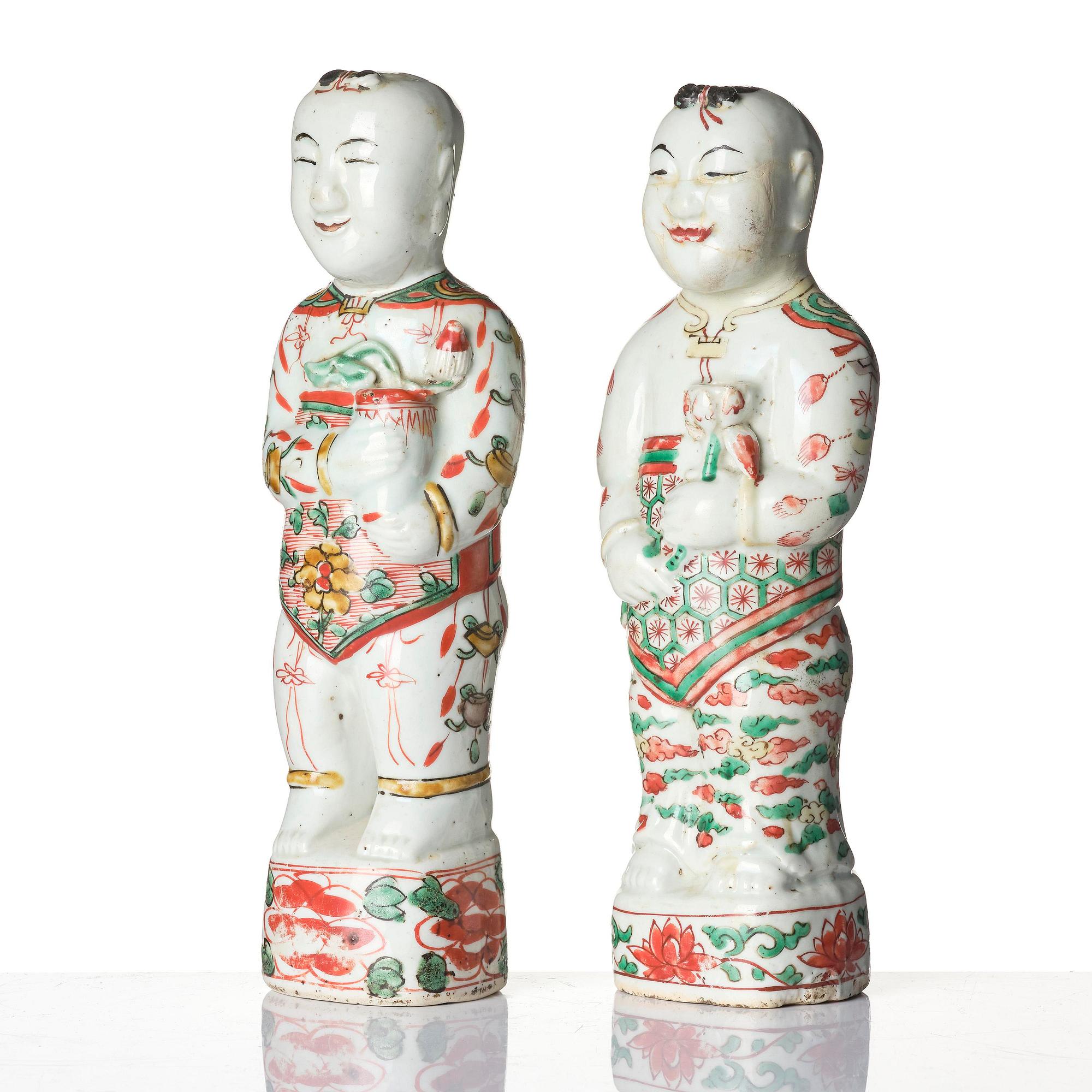 Three Chinese famille verte figures of laughing boys 'Hehe Erxian', 18th century.