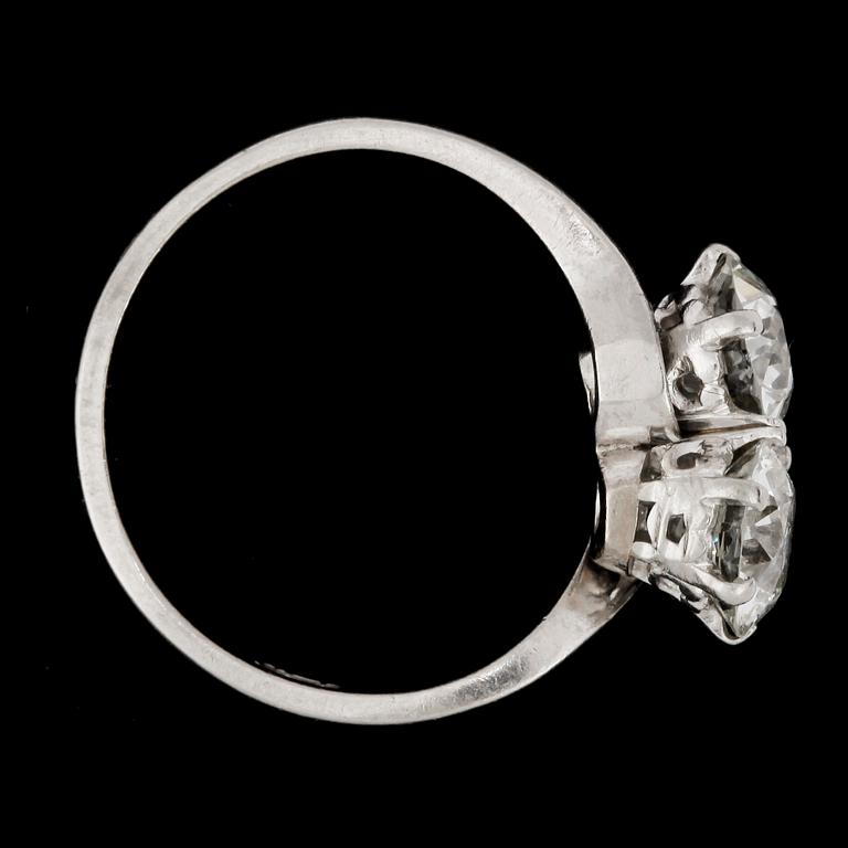 An old cut diamond ring, each stone app. 1.10 cts.